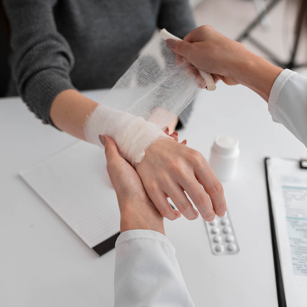 Doctor bandaging hand injury during wound care in Reno at Atrium Woundcare